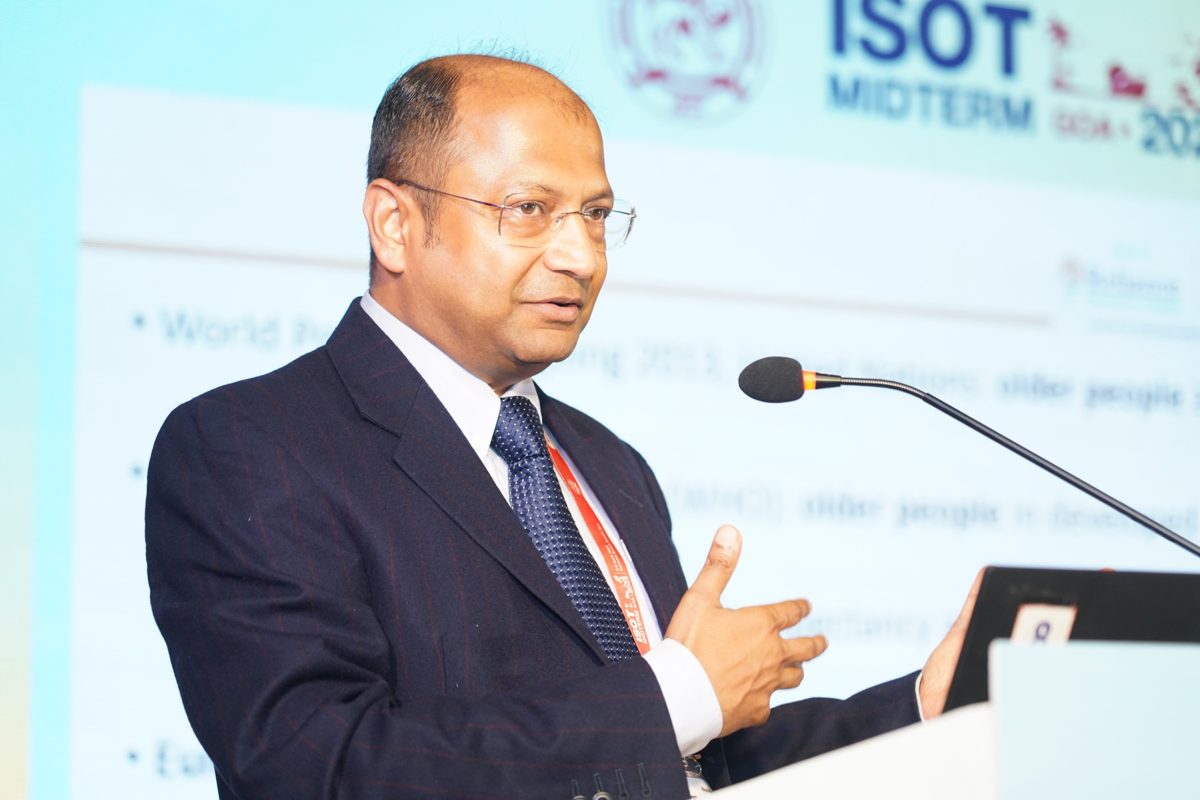 Dr. Mohanka speaking at a podium in front of the ISOT Midterm 2025 backdrop
